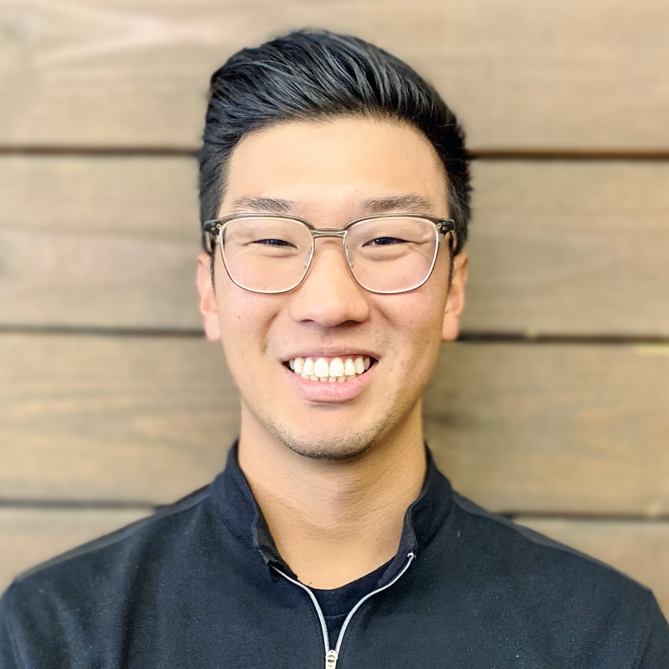Paul Roh, PT, DPT, CAFS, MOT Man with glasses smiling in front of green plants
